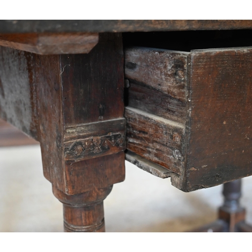 309 - A provincial 17th century oak and elm side table with cleated three-plank top over frieze drawer and... 