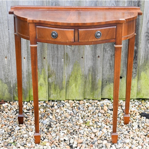 311 - A reproduction mahogany veneer hall table with two drawers, 78 x 36 x 74 cm h to/w an octagonal 'dru... 