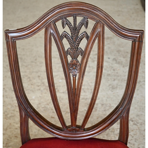 314 - #A set of six Edwardian mahogany Hepplewhite style shield-back dining chairs carved with wheat-sheaf... 