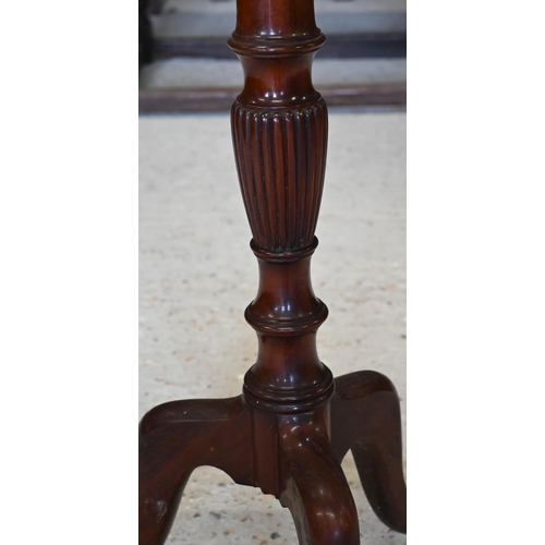 317 - A mahogany jardiniere stand on turned column and triform supports, 40 cm dia. x 122 cm h