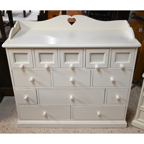 321 - An off-white painted child's bedroom chest, arrangement of thirteen drawers and galleried back with ... 