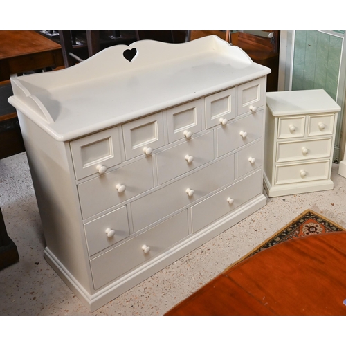 321 - An off-white painted child's bedroom chest, arrangement of thirteen drawers and galleried back with ... 