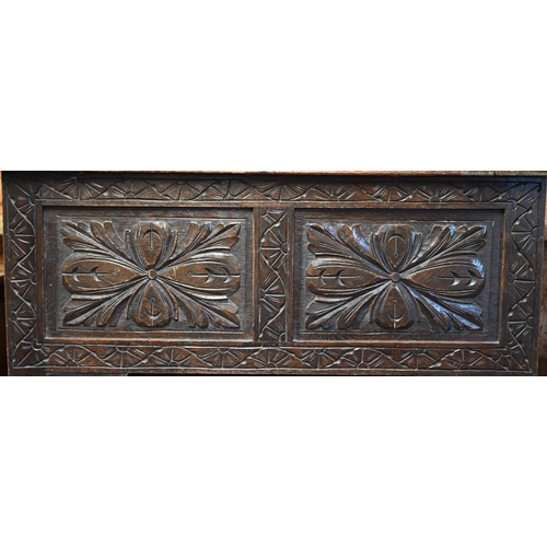 333 - A Gothic style oak monks' bench carved with armorial crest, foliate panels and roaring lion arms, 10... 