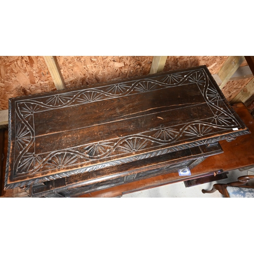 333 - A Gothic style oak monks' bench carved with armorial crest, foliate panels and roaring lion arms, 10... 