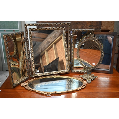 335 - An oval wall mirror in decorative gilt frame, gilt framed triptych mirror, pierced brass dressing ta... 