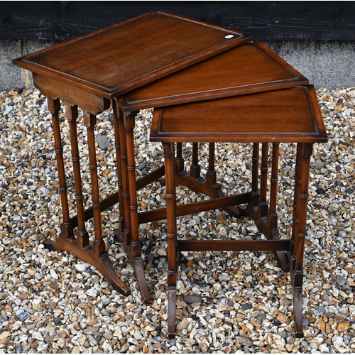 348 - A small mahogany folding games table to/w two tripod occasional tables, a small oak bookcase, nest o... 