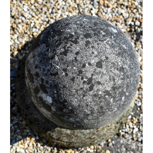 35 - A weathered cast stone ball finial, 34 cm h to/with a pair of small ball finials (3)