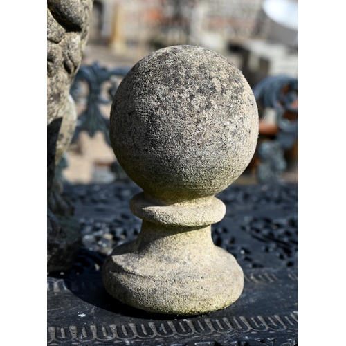 35 - A weathered cast stone ball finial, 34 cm h to/with a pair of small ball finials (3)