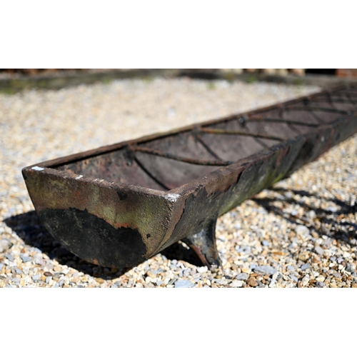 39 - A Victorian cast iron trough feeder, raised on four cast legs, 244 cm long x 30.5 cm wide x 19 cm h