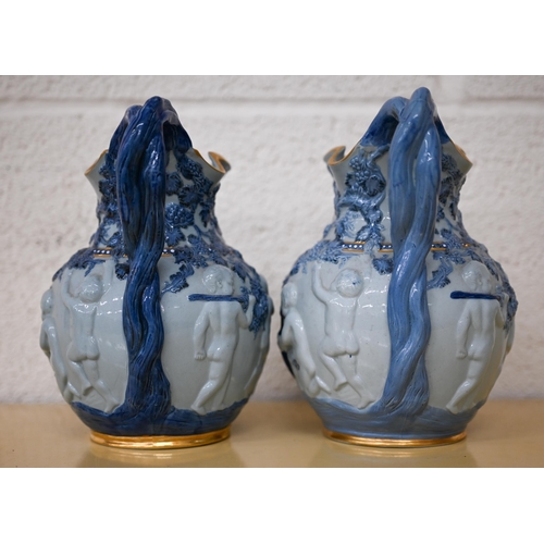 457 - Two Copeland 'Spode's Florentine' jugs, embossed with Bacchanalian putti, 20 cm high