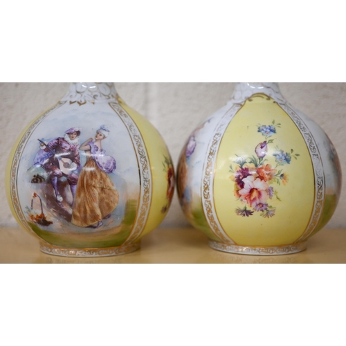 464 - A pair of Victoria (Carlsbad, Austria) ceramic bottle vases in the Dresden manner printed with fete ... 