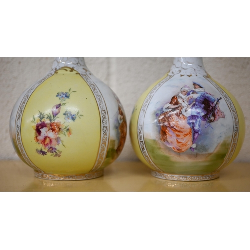 464 - A pair of Victoria (Carlsbad, Austria) ceramic bottle vases in the Dresden manner printed with fete ... 