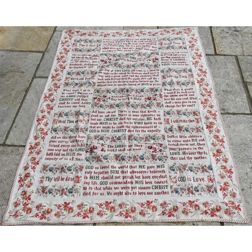 505 - A large antique fabric panel, cross-stitched with religious texts within floral-printed surround, 16... 