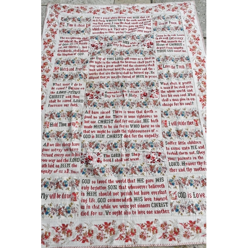 505 - A large antique fabric panel, cross-stitched with religious texts within floral-printed surround, 16... 