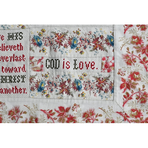 505 - A large antique fabric panel, cross-stitched with religious texts within floral-printed surround, 16... 