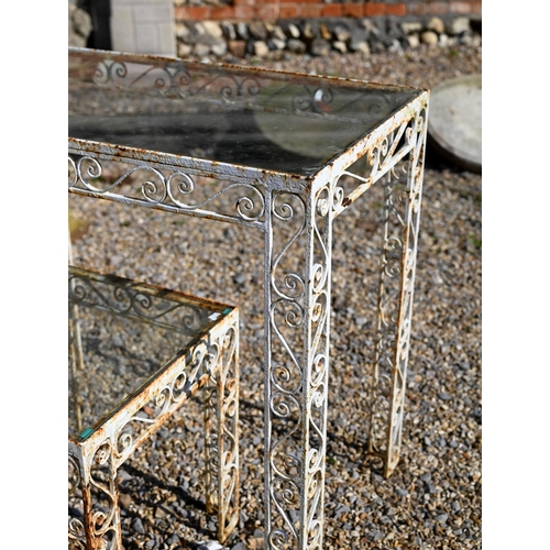 51 - A vintage wrought steel glass top garden table, 87.5 cm x 49.5 cm x 77 cm h to/with another smaller ... 