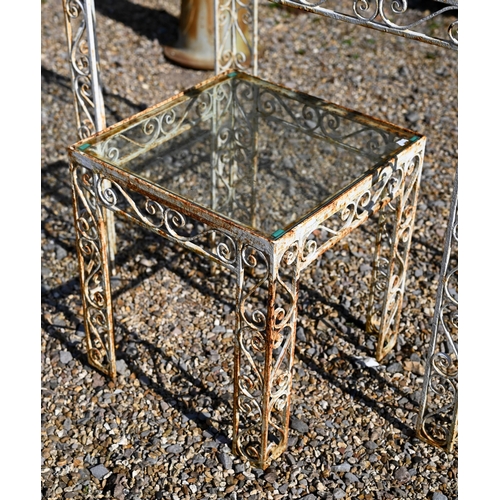 51 - A vintage wrought steel glass top garden table, 87.5 cm x 49.5 cm x 77 cm h to/with another smaller ... 