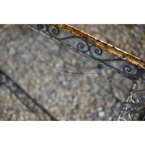 51 - A vintage wrought steel glass top garden table, 87.5 cm x 49.5 cm x 77 cm h to/with another smaller ... 