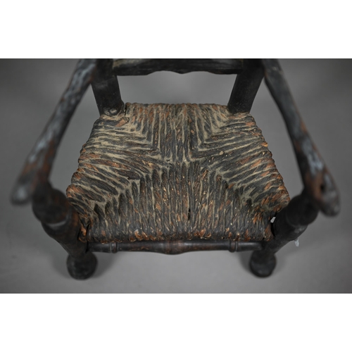 555 - An antique miniature ladderback armchair with rush seat, 35 cm