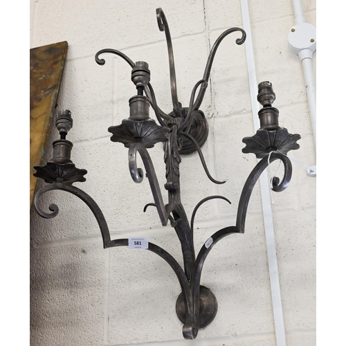 581 - A large scrolling metal three-sconce wall light, 65 cm high