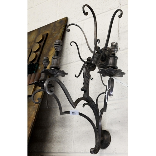 581 - A large scrolling metal three-sconce wall light, 65 cm high