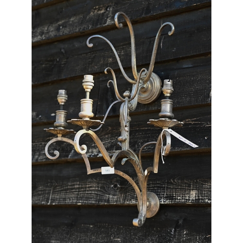 581 - A large scrolling metal three-sconce wall light, 65 cm high