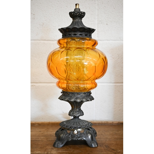 601 - An ornate brass table lamp with moulded amber glass shade, 56 cm