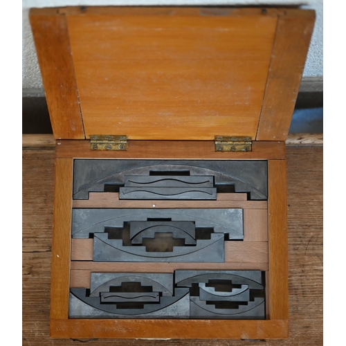 613 - A boxed vintage set of twelve Figgins (London) letterpess angle quads