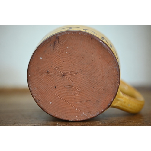 614 - #A slip-glazed earthenware mug decorated with Luftwaffe pilot's badge and inscribed 'Tony' 11 cm hig... 