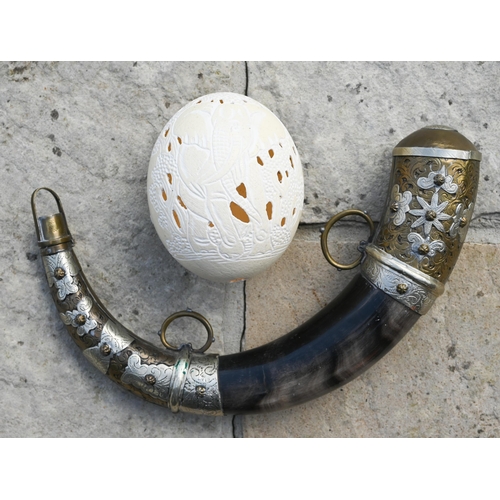 620 - An ornamental powder horn with metal mounts, a carved ostrich egg, a Tribal machete and an air rifle... 