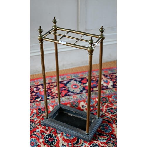 An antique six division brass stick-stand with cast iron base, 32 cm x 18 cm x 64 cm h