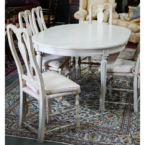 631 - A distressed off-white painted double d-end dining table and extension leaf, to/with a set of six di... 