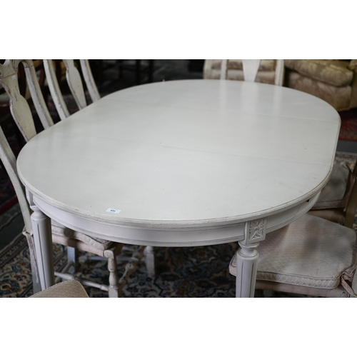 631 - A distressed off-white painted double d-end dining table and extension leaf, to/with a set of six di... 