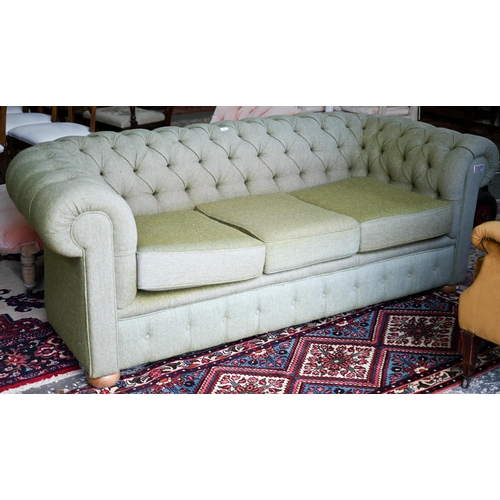 A traditional green herringbone Harris Tweed button backed Chesterfield sofa, on bun feet, 206 cm x 965 cm x 72 cm h (the seat 61 cm deep) some fading