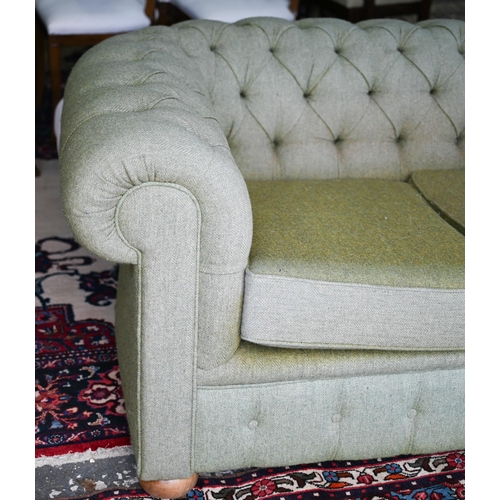 635 - A traditional green herringbone Harris Tweed button backed Chesterfield sofa, on bun feet, 206 cm x ... 