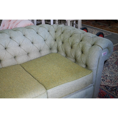 635 - A traditional green herringbone Harris Tweed button backed Chesterfield sofa, on bun feet, 206 cm x ... 