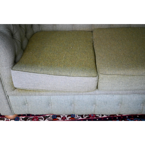 635 - A traditional green herringbone Harris Tweed button backed Chesterfield sofa, on bun feet, 206 cm x ... 