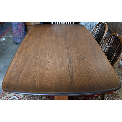 641 - An Ercol dark elm dining table on twin-trestle supports united by the central stretcher, 150 cm x 84... 