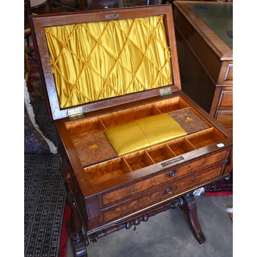 643 - A Victorian walnut sewing table with hinged top enclosing maple fitted interior with turned supports... 