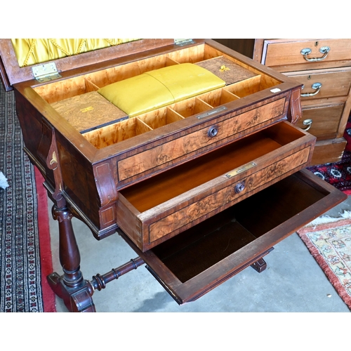 643 - A Victorian walnut sewing table with hinged top enclosing maple fitted interior with turned supports... 