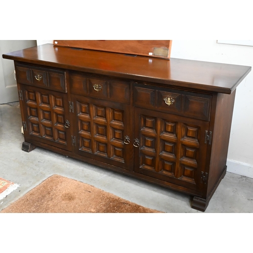 653 - A 'Younger' Toledo oak Spanish style sideboard with three frieze drawers above panelled doors, 157cm... 