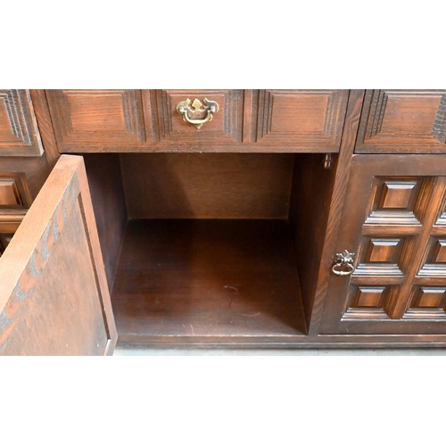 653 - A 'Younger' Toledo oak Spanish style sideboard with three frieze drawers above panelled doors, 157cm... 