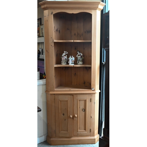 654 - #A waxed pine corner cabinet with open shelves above two panelled doors