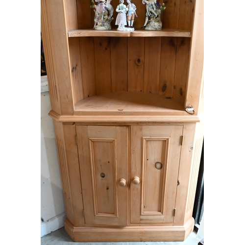 654 - #A waxed pine corner cabinet with open shelves above two panelled doors