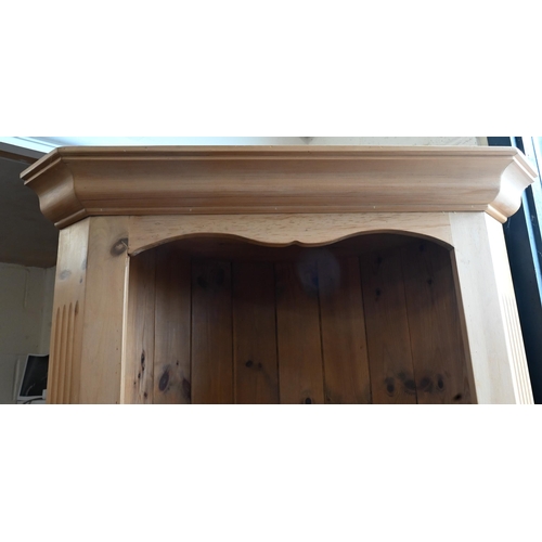 654 - #A waxed pine corner cabinet with open shelves above two panelled doors