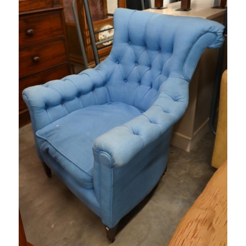 655 - A deep-buttoned armchair covered in blue twill fabric, on tapering supports