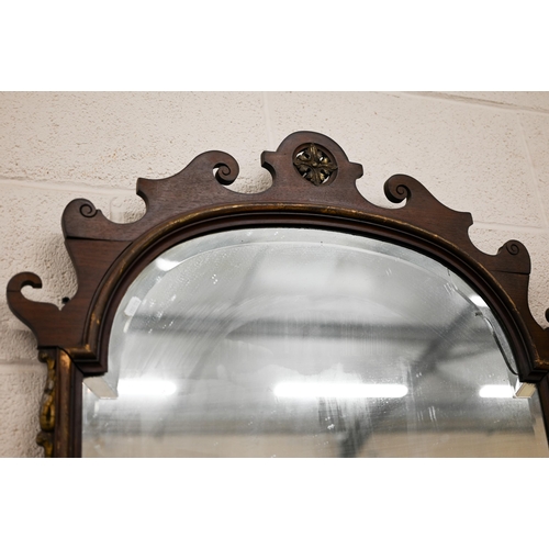 659 - Large fret-cut mahogany framed mirror with arched and bevelled plate in parcel gilt frame 105 x 70cm... 