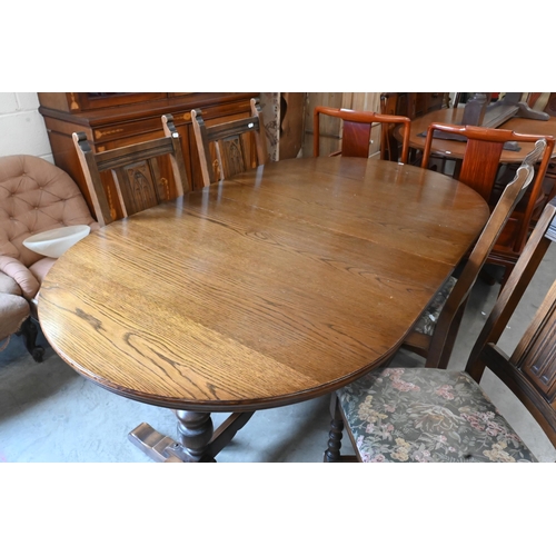 660 - A 'Wood Brothers' Old Charm extending dining table with leaf, on turned pillars tied with a stretche... 