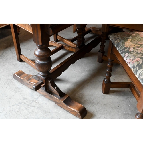 660 - A 'Wood Brothers' Old Charm extending dining table with leaf, on turned pillars tied with a stretche... 