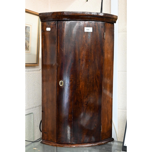 668 - A small antique barrel front hanging corner cupboard, 65 cm h